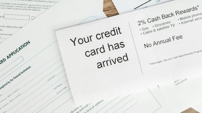 Close-up of a letter announcing the arrival of a credit card amidst financial documents.