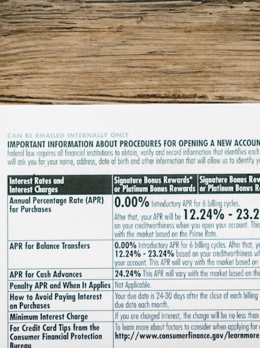 A detailed financial document listing interest rates on a textured wooden table.