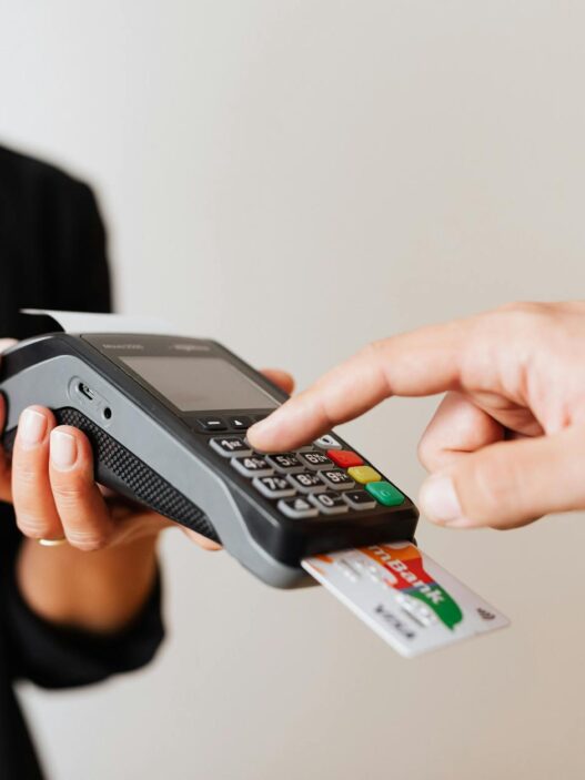 A customer using a contactless payment terminal for secure and cashless transactions indoors.