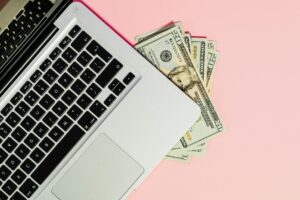 Freelancer working on laptop managing side hustle finances