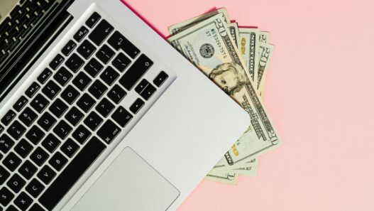 Freelancer working on laptop managing side hustle finances