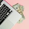 Freelancer working on laptop managing side hustle finances
