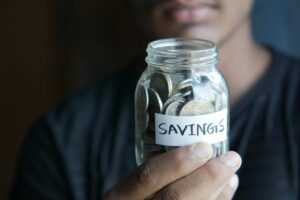 Coins in a savings jar representing the 52-week savings challenge