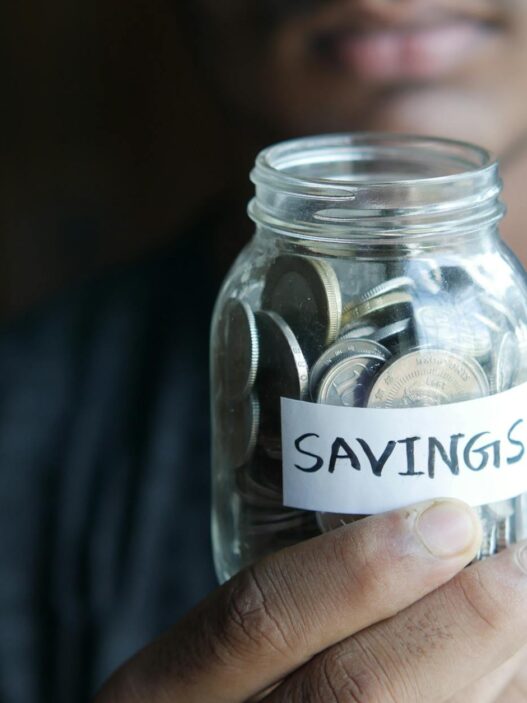Coins in a savings jar representing the 52-week savings challenge