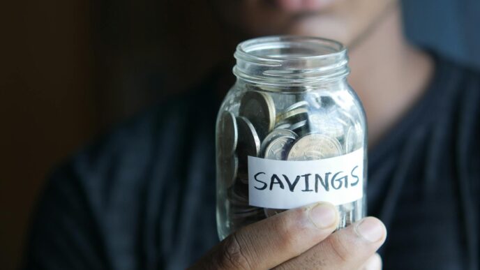 Coins in a savings jar representing the 52-week savings challenge