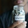 Coins in a savings jar representing the 52-week savings challenge