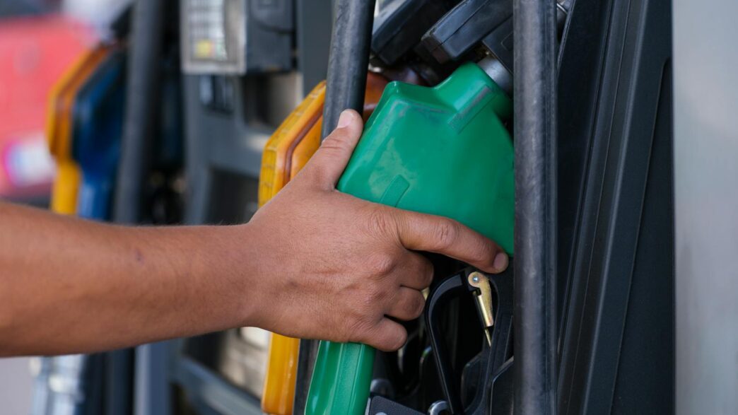 Driver filling up car at gas station pump