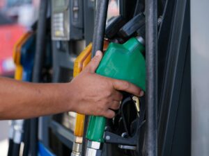 Driver filling up car at gas station pump