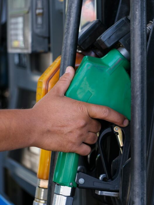 Driver filling up car at gas station pump
