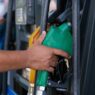 Driver filling up car at gas station pump