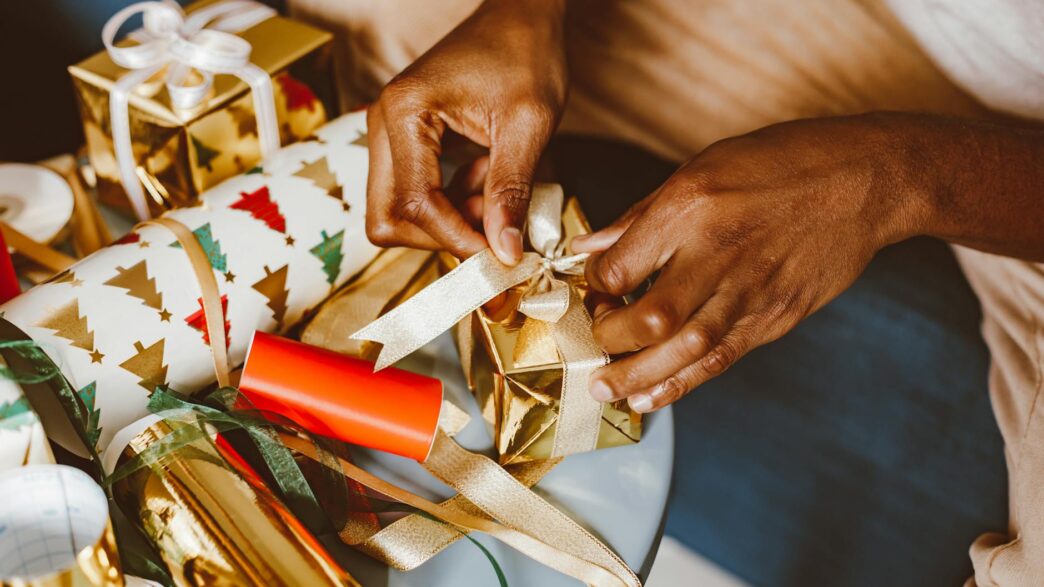 Wrapped Christmas gifts and a cash savings jar set aside for the holiday season