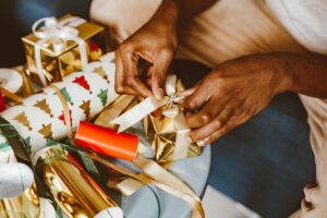 Wrapped Christmas gifts and a cash savings jar set aside for the holiday season
