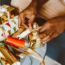 Wrapped Christmas gifts and a cash savings jar set aside for the holiday season