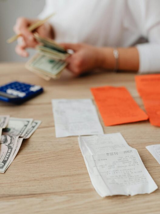 Stack of US cash next to a flashlight and storm preparation supplies, illustrating a hurricane season emergency cash kit