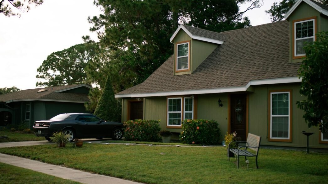Suburban home with well-maintained roof and landscaping, illustrating homeowners insurance premium and storm preparation savings