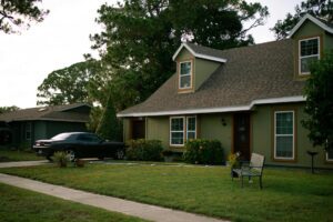 Suburban home with well-maintained roof and landscaping, illustrating homeowners insurance premium and storm preparation savings