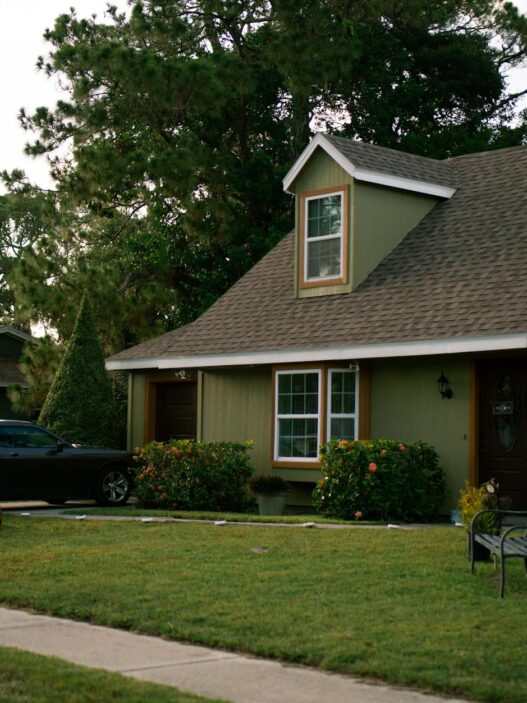 Suburban home with well-maintained roof and landscaping, illustrating homeowners insurance premium and storm preparation savings