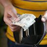 A wallet next to coins and a notebook representing a no-spend savings challenge