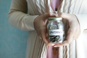 Glass savings jars labeled with different financial goals