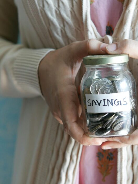 Glass savings jars labeled with different financial goals