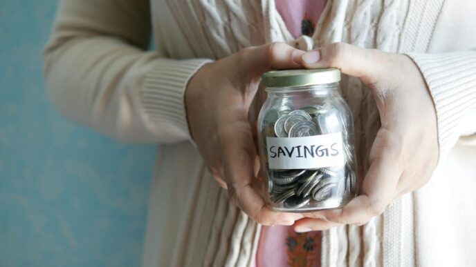 Glass savings jars labeled with different financial goals