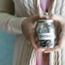 Glass savings jars labeled with different financial goals