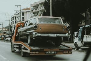 Tow truck assisting a car on the side of a highway