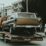 Tow truck assisting a car on the side of a highway