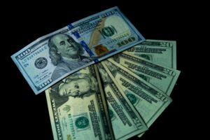 Stacks of US dollar bills representing cash bonuses paid by banks for opening new checking accounts
