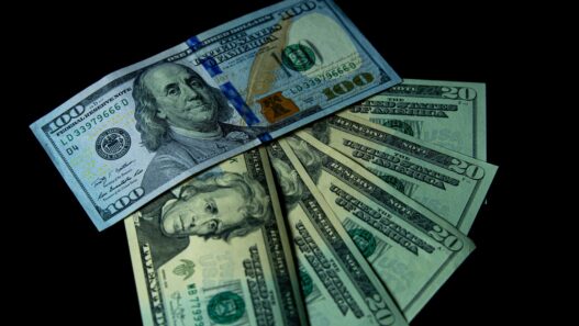 Stacks of US dollar bills representing cash bonuses paid by banks for opening new checking accounts
