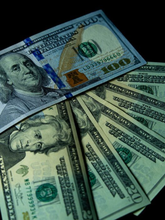 Stacks of US dollar bills representing cash bonuses paid by banks for opening new checking accounts