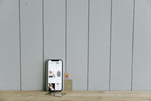 Person using a mobile banking app on a smartphone while shopping