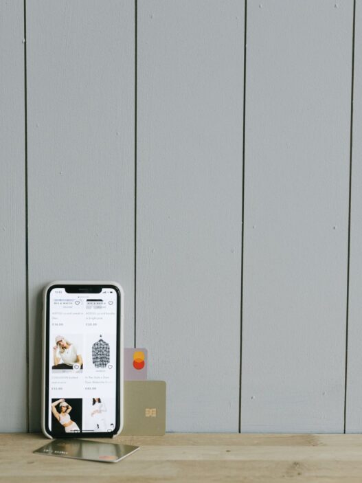 Person using a mobile banking app on a smartphone while shopping