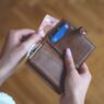 A credit card and cash representing cash-back rewards earned on everyday spending