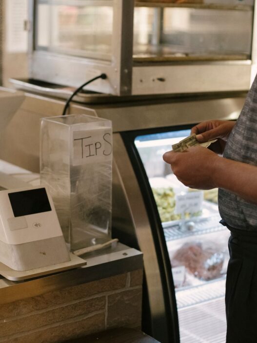 Shopper at a store checkout counter deciding on a purchase