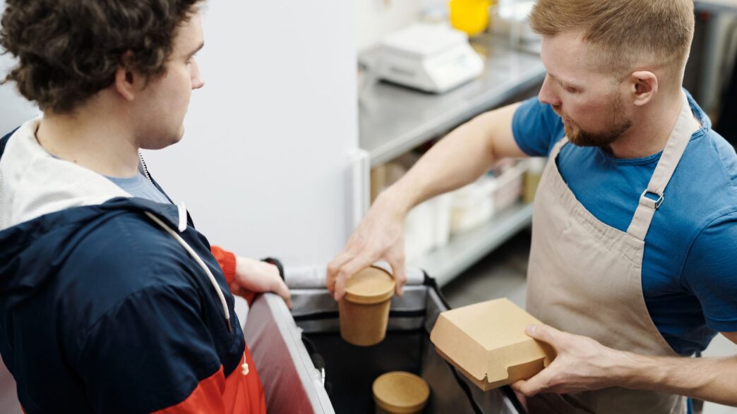 Food delivery takeout order being handed over