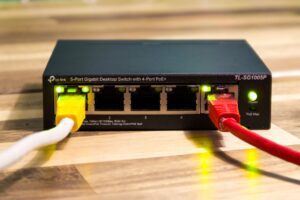 A home Wi-Fi router on a desk, illustrating how to lower your monthly internet bill in 2026.