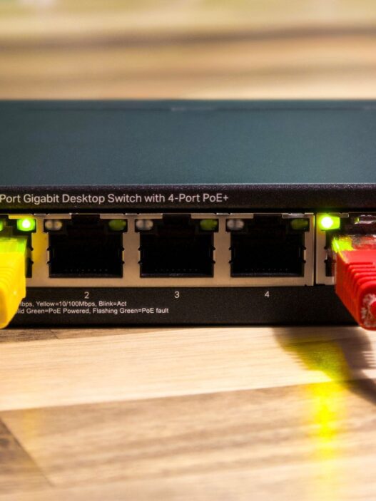 A home Wi-Fi router on a desk, illustrating how to lower your monthly internet bill in 2026.