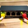 A home Wi-Fi router on a desk, illustrating how to lower your monthly internet bill in 2026.