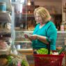 Fresh groceries and a shopping list on a kitchen counter representing weekly meal planning to save money