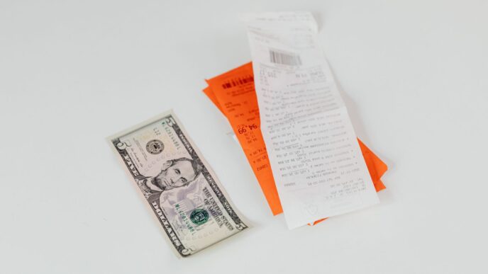 A shopper holding a receipt at a store checkout, illustrating how to request a price adjustment refund when a price drops
