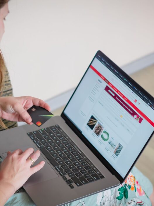 Person shopping online with a laptop and credit card