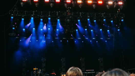 Crowd at an outdoor summer concert with stage lights