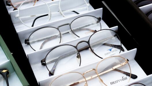 Rows of prescription eyeglasses frames on display in an optical shop