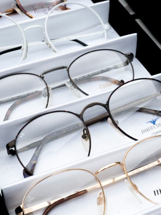 Rows of prescription eyeglasses frames on display in an optical shop