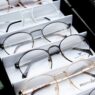 Rows of prescription eyeglasses frames on display in an optical shop