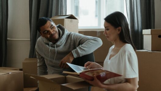 Moving boxes stacked in an empty room during a summer move