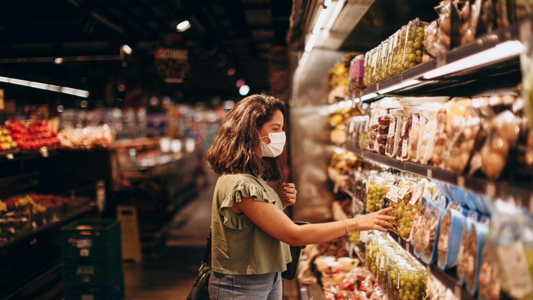 Grocery store shelves stocked with products representing store-brand vs name-brand savings