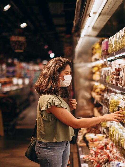Grocery store shelves stocked with products representing store-brand vs name-brand savings