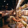 Grocery store shelves stocked with products representing store-brand vs name-brand savings